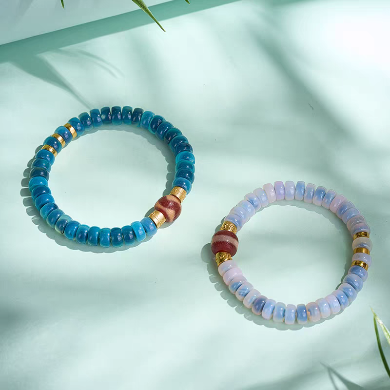 Natural red mutton tiger fang blue bubble Dzi beads bracelet inspired by Tibetan Buddhist jewelry culture, handcrafted for men and women to enhance fortune and mindfulness.