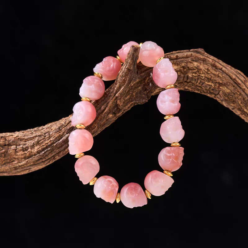 Handcrafted lucky pink Litchi frozen coralline beads bracelet, Tibetan Buddhist jewelry art piece promoting peace, luck, and protection.