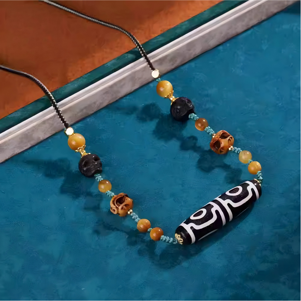 Handcrafted jewelry art clavicle necklace featuring a sacred four-eye Dzi, representing the four great blessings in Tibetan traditions.