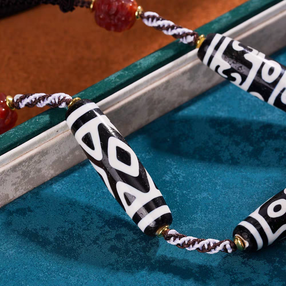 Purely handmade black and white Dzi beads necklace with phoenix motifs, reflecting the heritage of Tibetan Buddhist Jewelry Culture jewelry art.