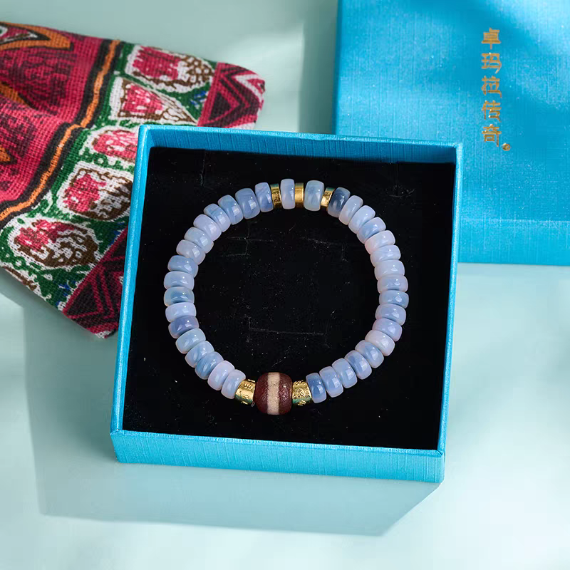 Red Line Medicine Beads Blue Pop Dzi bracelet, handcrafted in Tibetan Buddhist jewelry culture, offering protection, luck, and exquisite jewelry art.