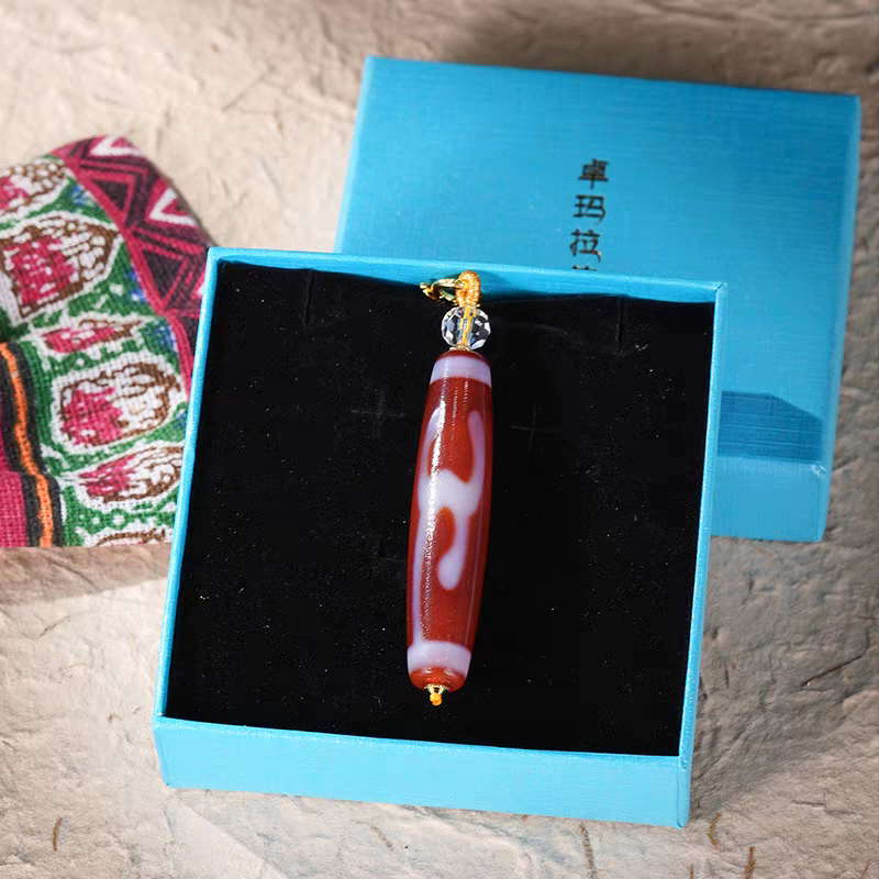 Handcrafted jewelry art pendant featuring a sacred Green Tara Dzi bead, representing compassion and success in Tibetan traditions.