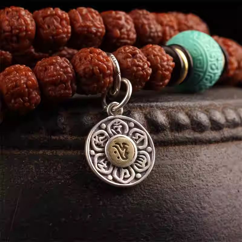 Handcrafted jewelry art sacred lotus charm with mantra engraving, representing compassion and enlightenment.
