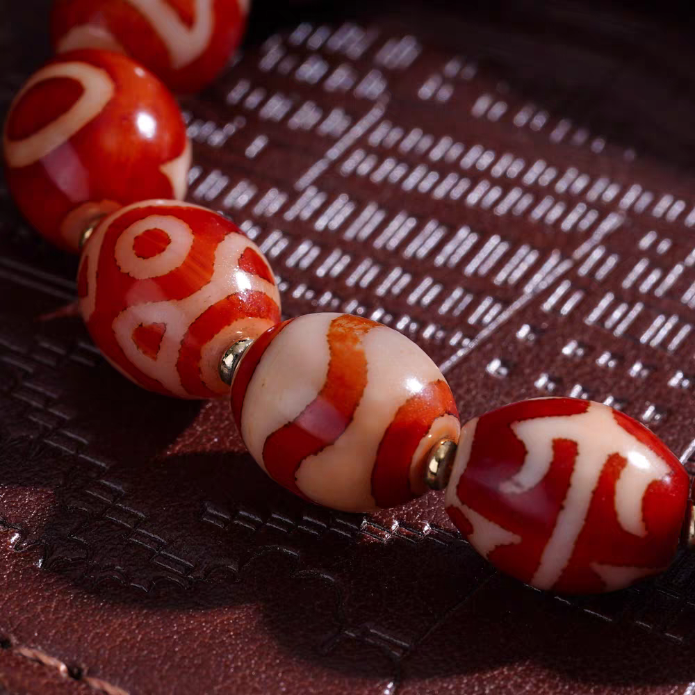 Red mutton multi-gem Dzi bead bracelet inspired by Tibetan Buddhist jewelry culture, handcrafted to attract luck, wealth, and spiritual balance