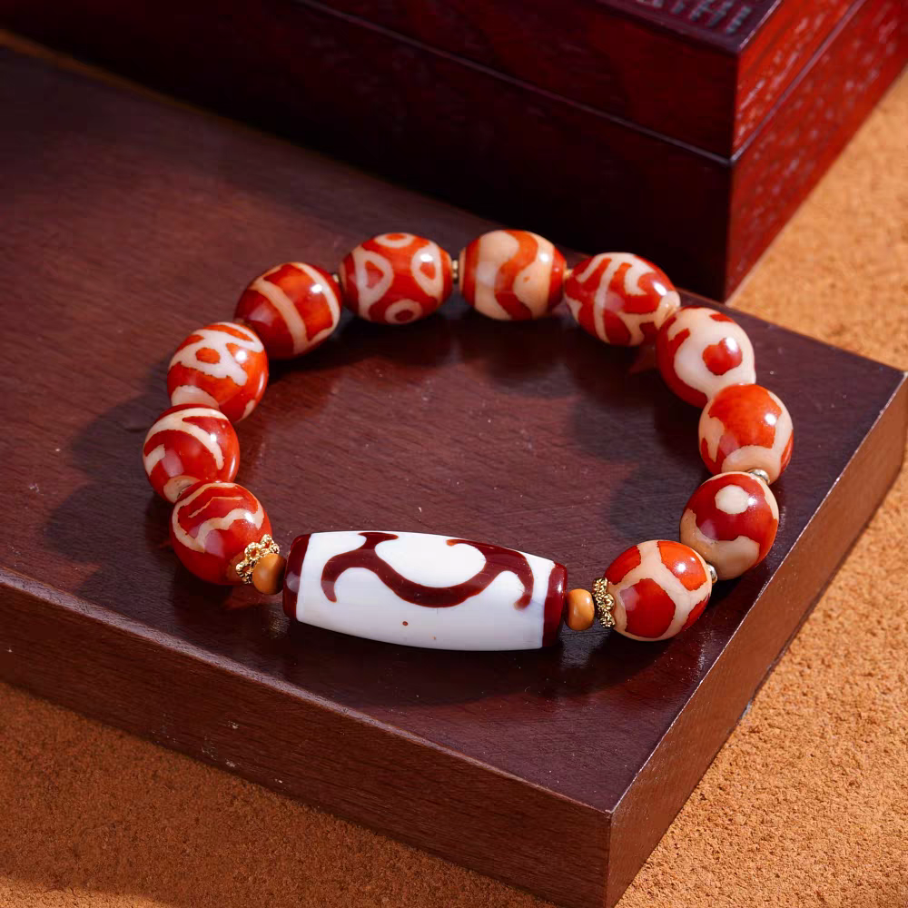Handcrafted red mutton gemstone Dzi bead bracelet, unisex Tibetan Buddhist jewelry art piece, enhancing luck, protection, and personal energy.