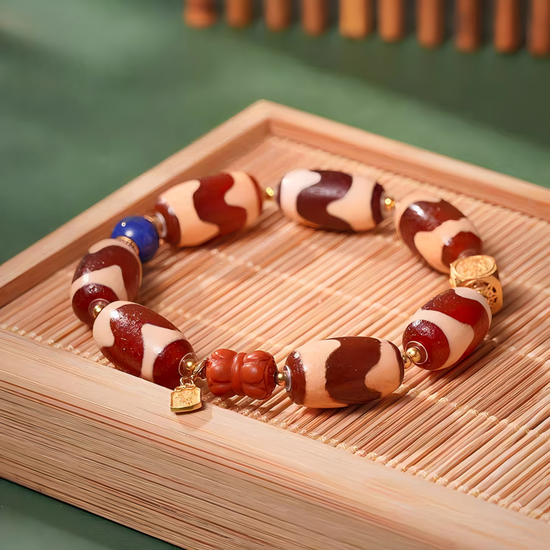 Red mutton tiger fang multi-gem handmade bracelet from Tibetan Buddhist jewelry culture, combining beauty, spiritual meaning, and luck for men and women.