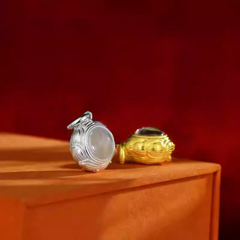 Hand-polished silver round lotus Ghau pendant, showcasing Tibetan Buddhist Jewelry Culture and artisan Jewelry art.