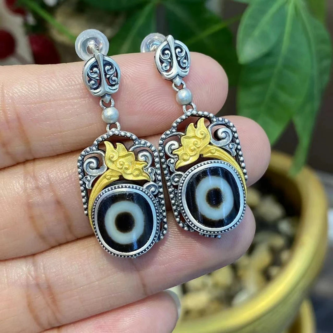 Hand-painted silver Yellow Jambhala and Green Tara Zhakiram earrings, combining Tibetan Buddhist jewelry culture and art, offering spiritual protection and wealth.
