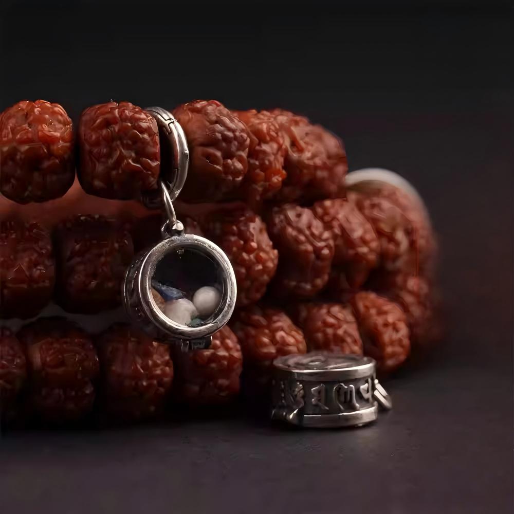 Tiny handmade sterling silver openable Ghau box mala beads, showcasing Tibetan Buddhist Jewelry Culture and jewelry art.
