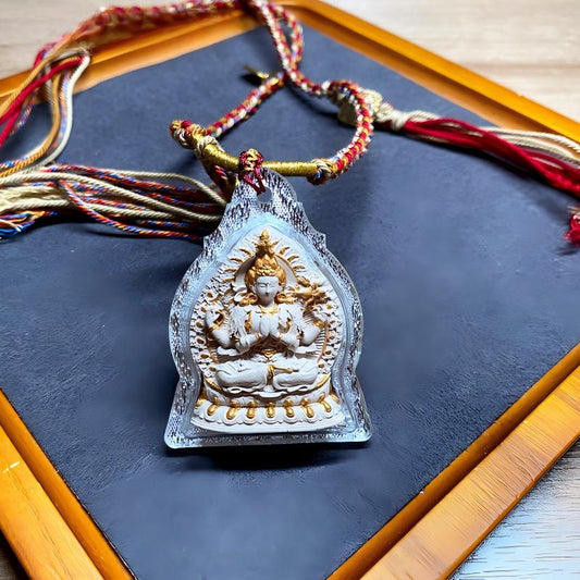 Handcrafted Tibetan Four-Armed Avalokiteshvara Ash mini Thangka pendant, blending spiritual symbolism with exquisite Tibetan jewelry art.