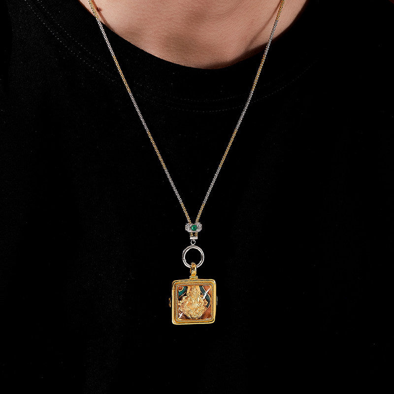 Handcrafted Tibetan Buddhist Yellow Jambhala silver pendant with white crystal and red cinnabar, combining ethnic style and Jewelry Art craftsmanship.