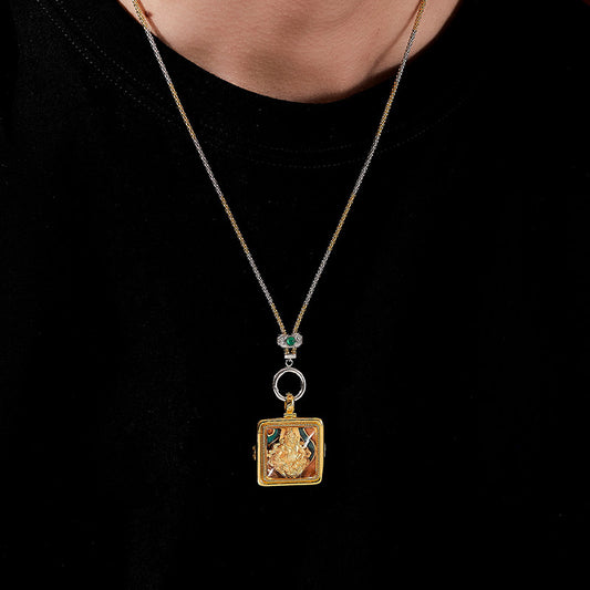 Handcrafted Tibetan Buddhist Yellow Jambhala silver pendant with white crystal and red cinnabar, combining ethnic style and Jewelry Art craftsmanship.