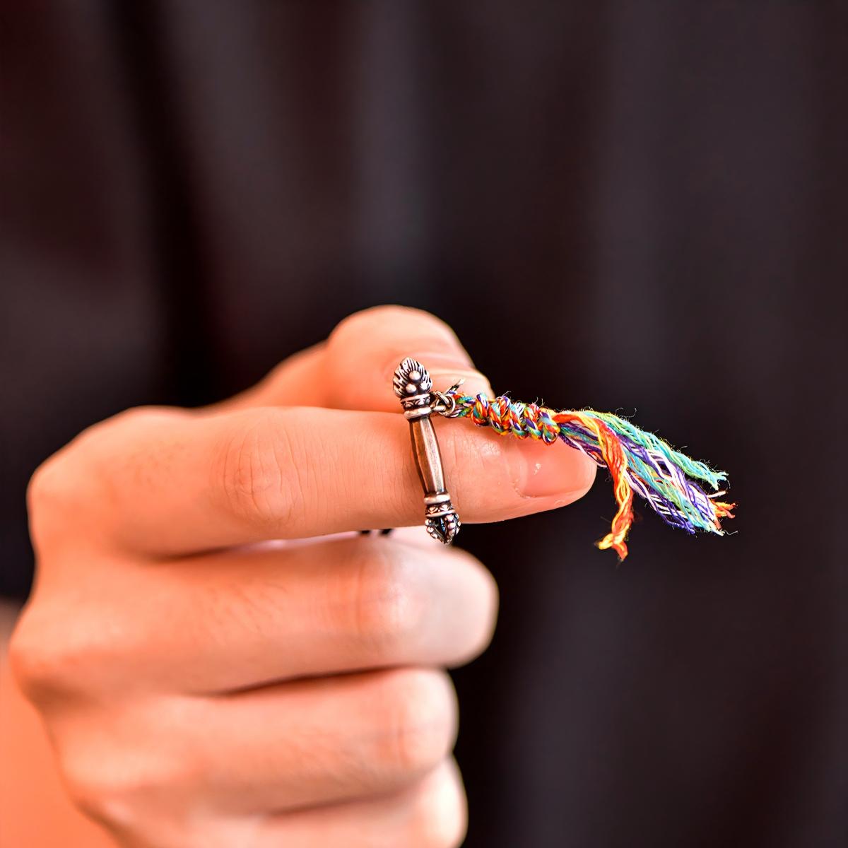 Tibetan Buddhist Jewelry Culture: Sacred silver accessory featuring the Gesar Scepter, a unique fusion of protective amulet and Buddhist art.
