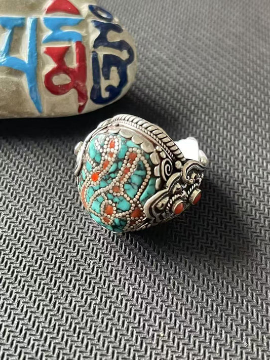 Handmade 925 silver turquoise ring inspired by Tibetan Buddhist Jewelry Culture, featuring intricate jewelry art and traditional hand-painted details.