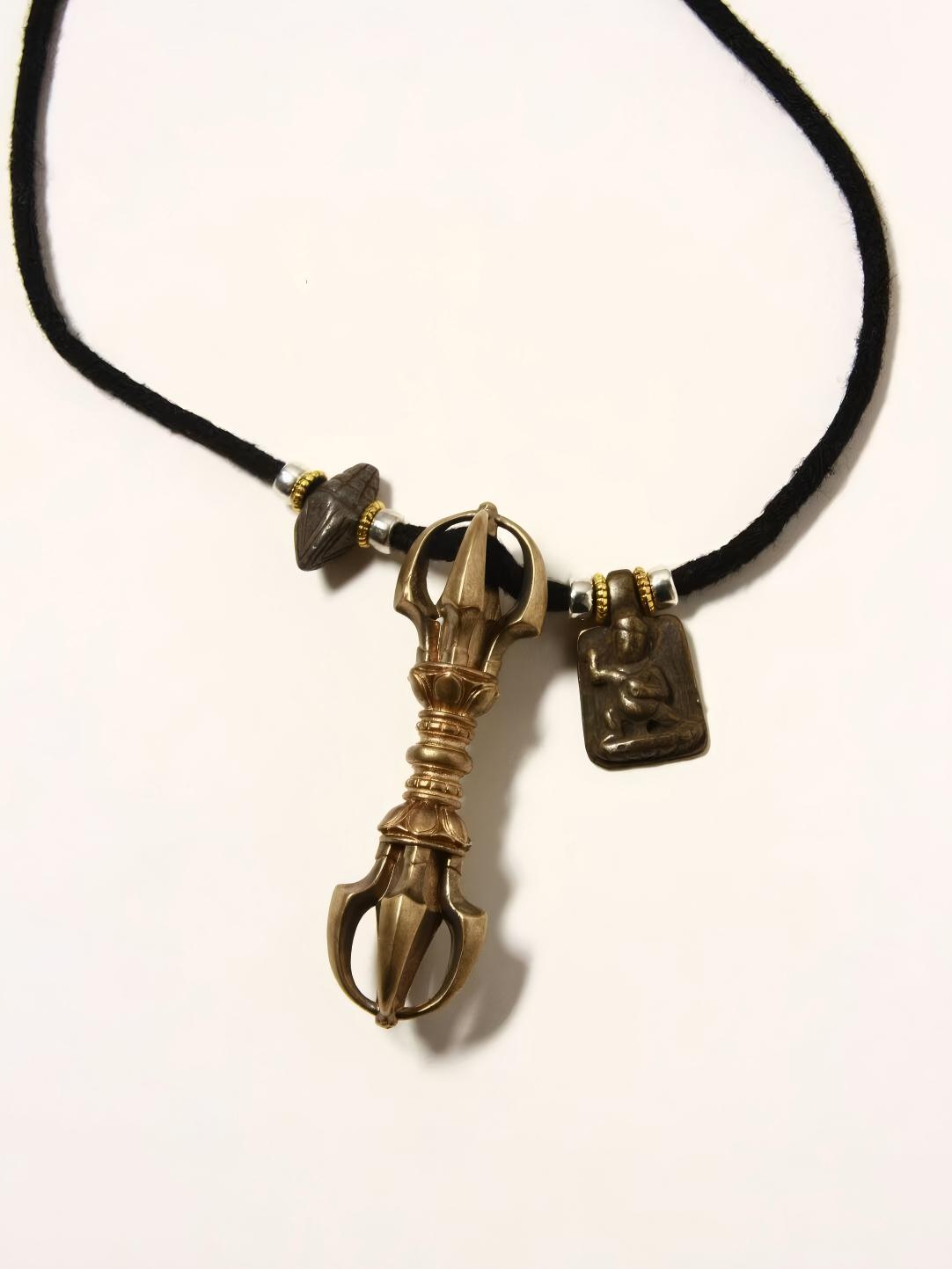 Featuring a small edition Vajra design with dual respect, this Tibetan Buddhist jewelry showcases oxidized effects and defects in its handcrafted accessories. It represents Tibetan Buddhist artistry, blending deep cultural meaning with craftsmanship.