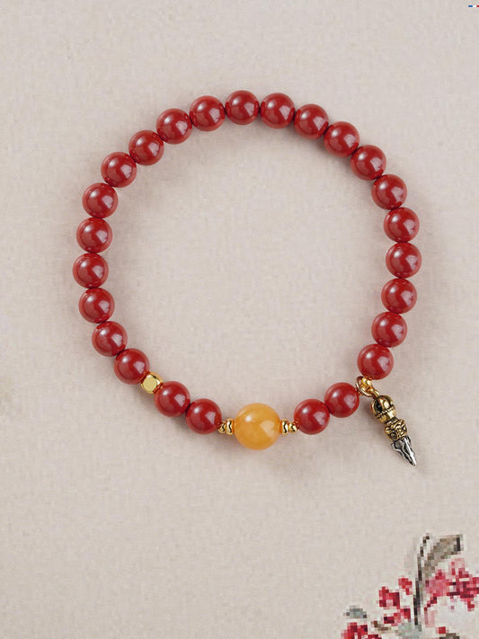 Hand-painted Cinnabar and Amber wealth bracelet in Tibetan Buddhist jewelry culture, combining sacred materials for prosperity and success.