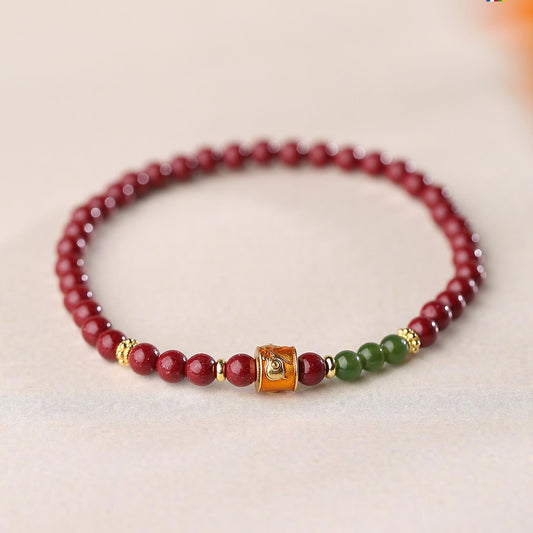 Hand-painted Cinnabar and Jade auspicious bracelet in Tibetan Buddhist jewelry culture, combining sacred materials for eternal harmony.