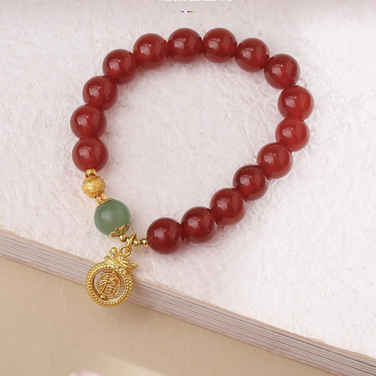 Main product image of Morning Blossom Hand-Painted Agate Bracelet. Features natural red agate beads with exquisite hand-painted patterns, each bead meticulously crafted by artisans, embodying the essence of Tibetan Buddhist jewelry art.
