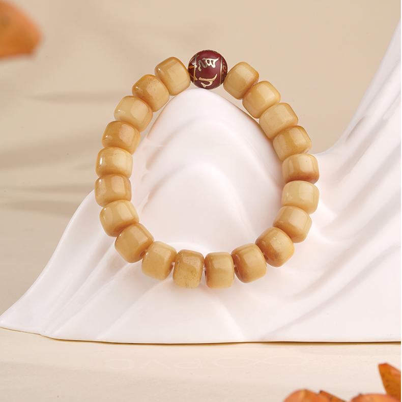 Hand-painted bone ash beads protection amulet in Tibetan Buddhist jewelry culture, crafted with sacred incense ashes and ritual symbols.