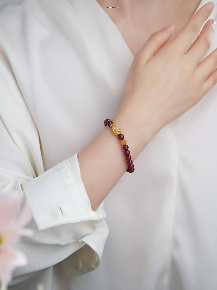 Cinnabar Bliss bracelet with quartzite jade accents, showcasing Tibetan Buddhist jewelry art for joyful relationships