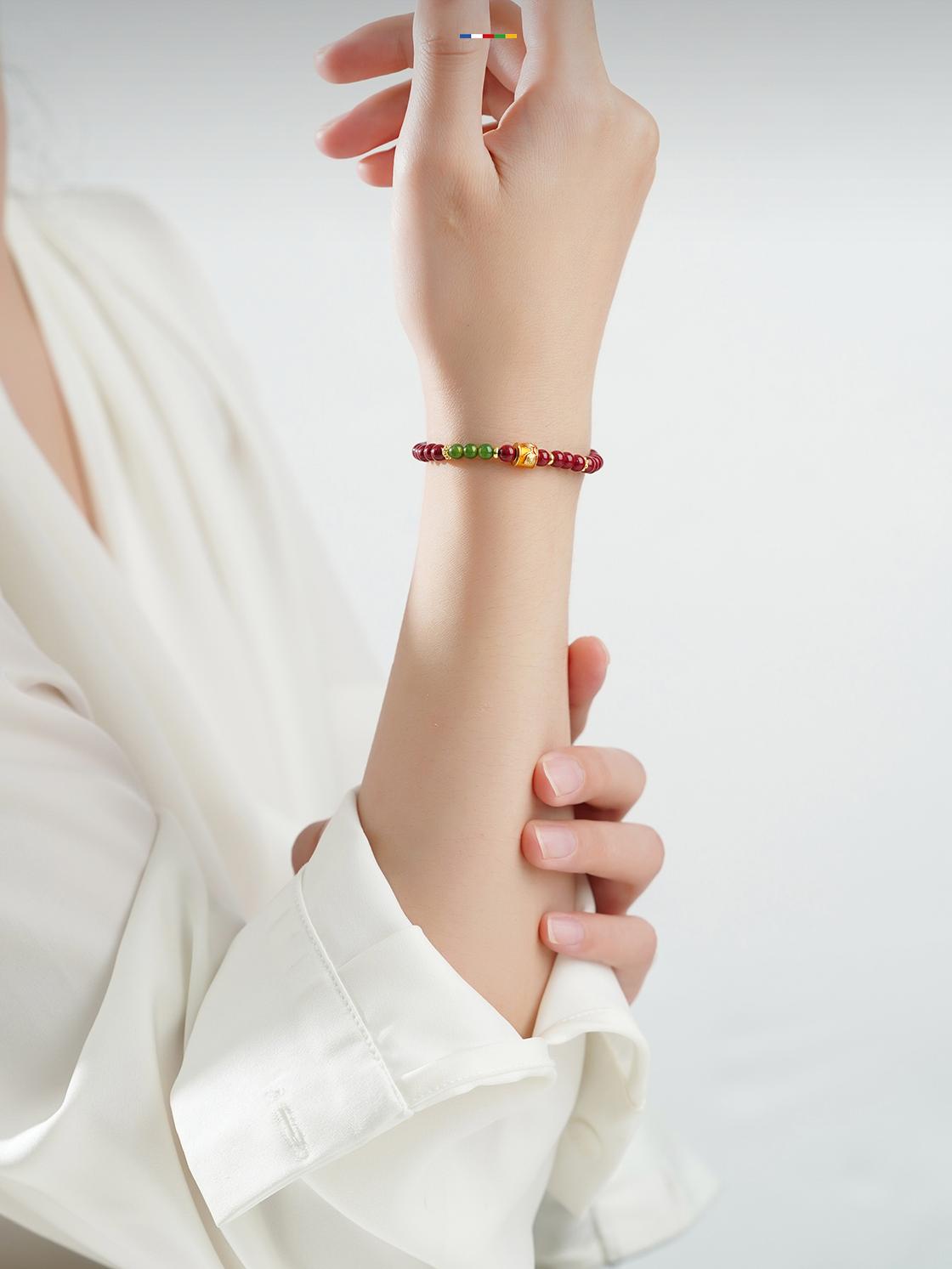 Artisanal Cinnabar and Jade beads in Tibetan Buddhist jewelry tradition, meticulously hand-painted with sacred mantras for divine connection.