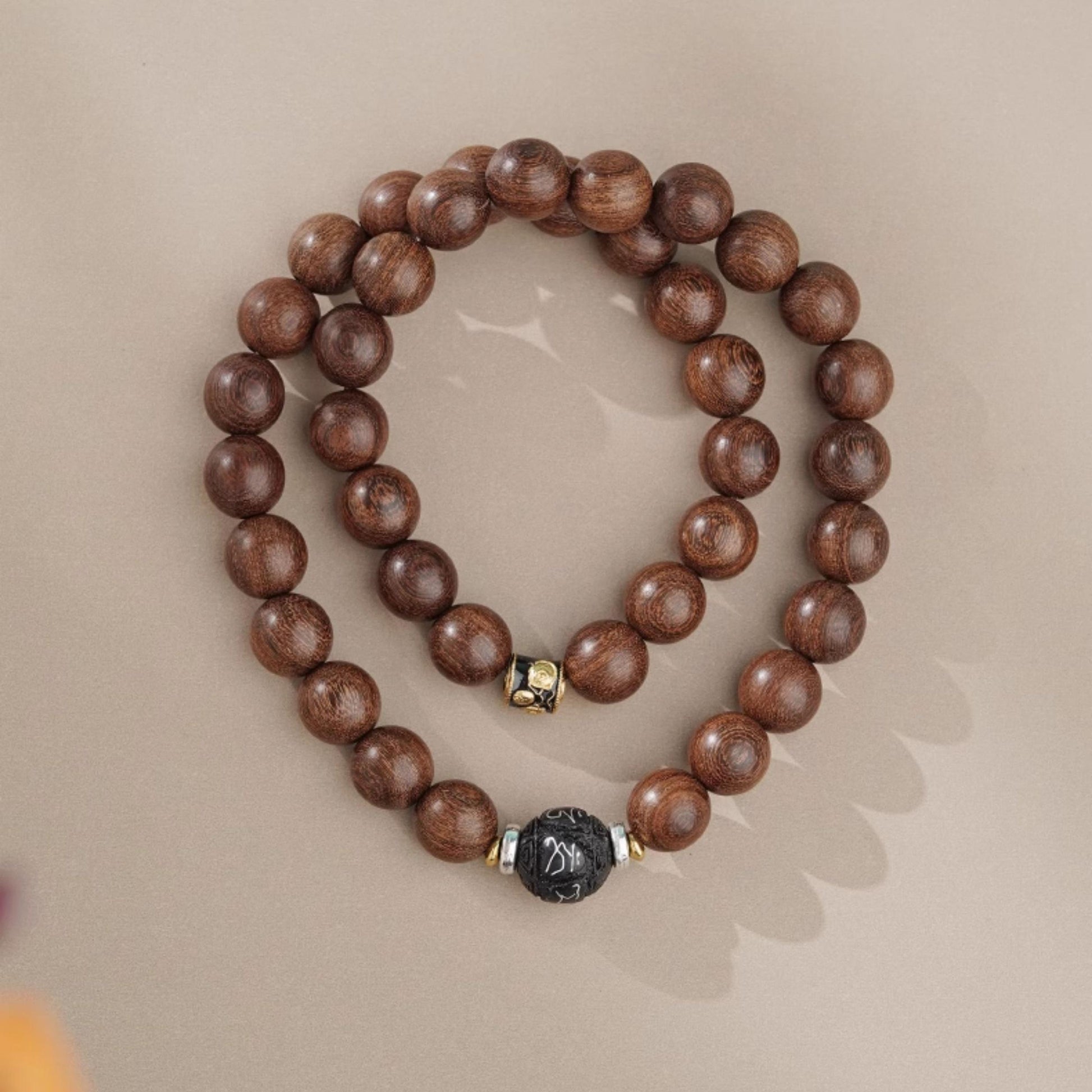 Styling shot of the artistic handcrafted multi-circle wood bracelet. Shows the layered beauty on the wrist, with the warm luster of golden sandalwood perfectly complementing the skin tone, creating a subtle and elegant look.