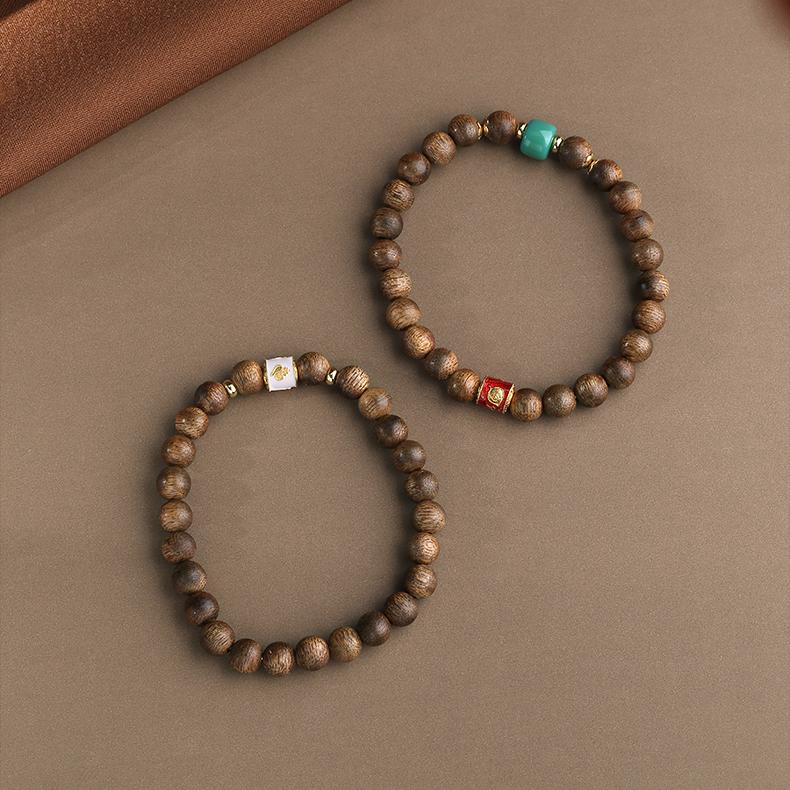 Hand-painted Falling Petals agarwood beads in Tibetan Buddhist jewelry tradition, featuring floral motifs for mindful meditation.
