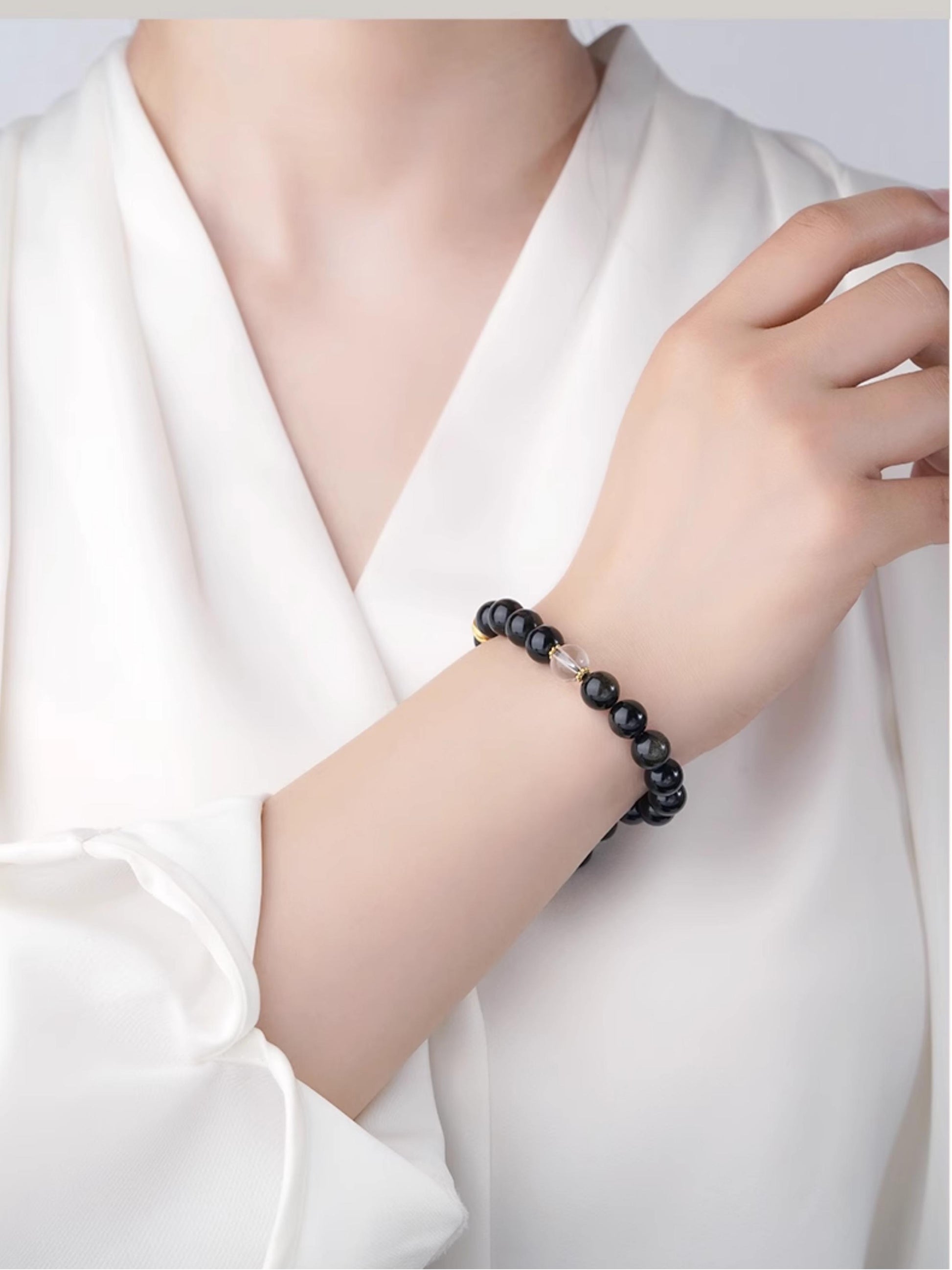 Golden Obsidian Night Light bracelet channeling wealth energy through Tibetan Buddhist jewelry art craftsmanship.