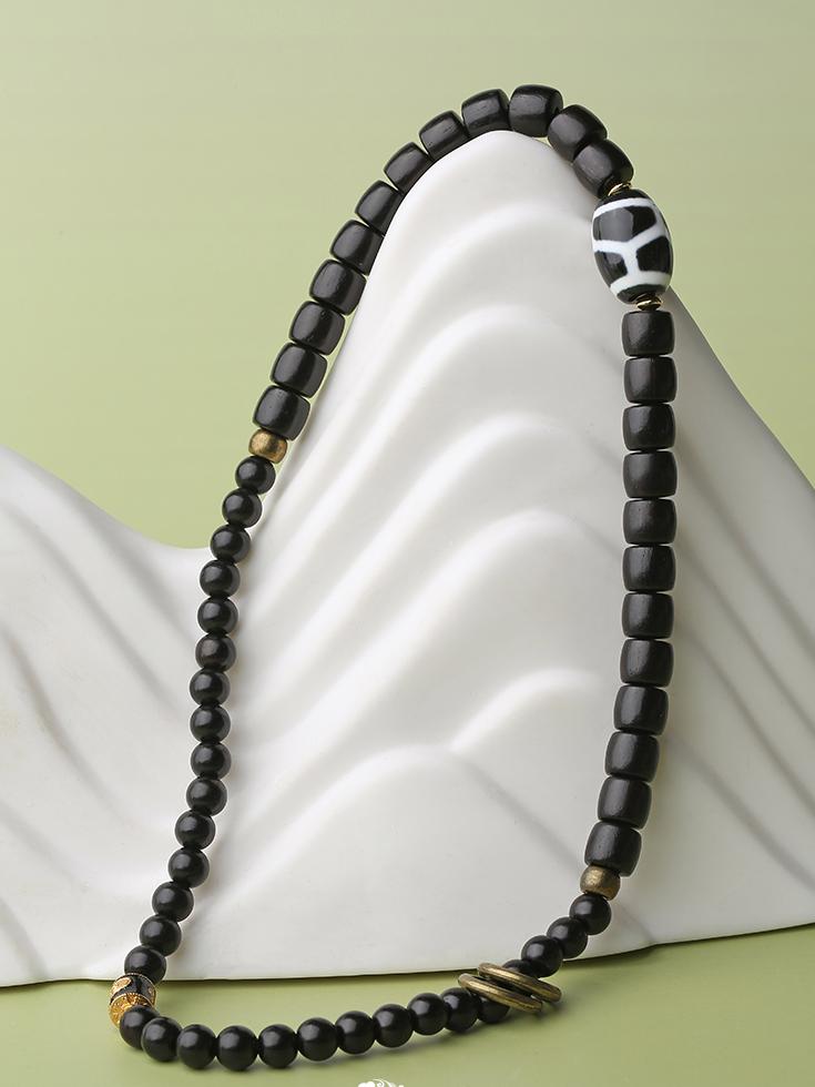 A multi-circle meditation bracelet crafted from black sandalwood and hand-painted agate. This authentic Tibetan Buddhist jewelry art accessory aids in mindfulness and deep meditation practice.