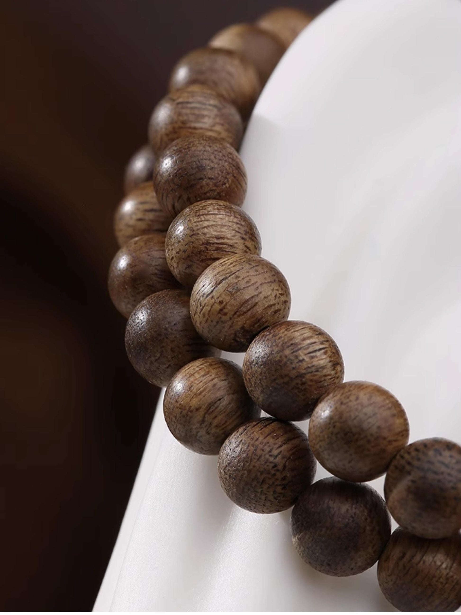 Artisanal Falling Petals agarwood beads representing Tibetan Buddhist jewelry culture, hand-painted with sacred floral patterns.