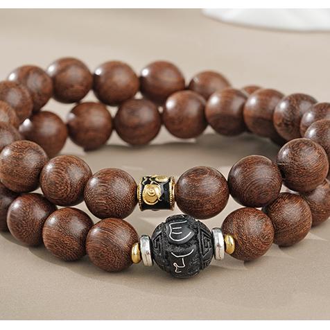 Extreme close-up of individual golden sandalwood beads. Showcases the unique "golden thread" luster and crystalline grain within the wood, highlighting nature's beauty and the warm texture achieved through hand-polishing.