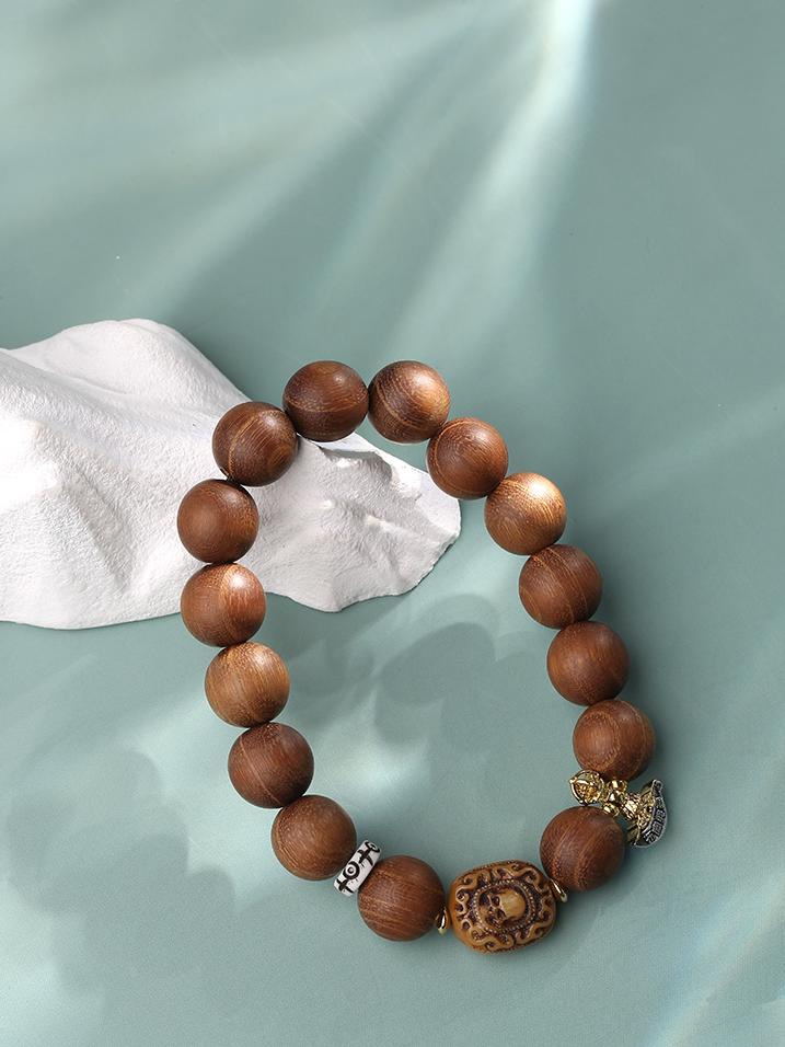 Showcasing the pure handmade craftsmanship of the Golden Sandalwood Bracelet. Each bead is meticulously polished and strung by hand, resulting in a smooth, lustrous finish that reflects the dedication to pure handmade quality in Tibetan Buddhist jewelry culture.