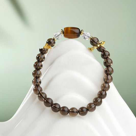  A detailed close-up of a hand-painted Tiger's Eye bracelet in brown crystal, showcasing authentic Tibetan Buddhist Jewelry Culture and intricate jewelry art.