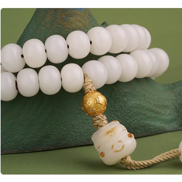 Artisanal white Bodhi beads for spiritual awakening, showcasing detailed Tibetan Buddhist jewelry art craftsmanship.
