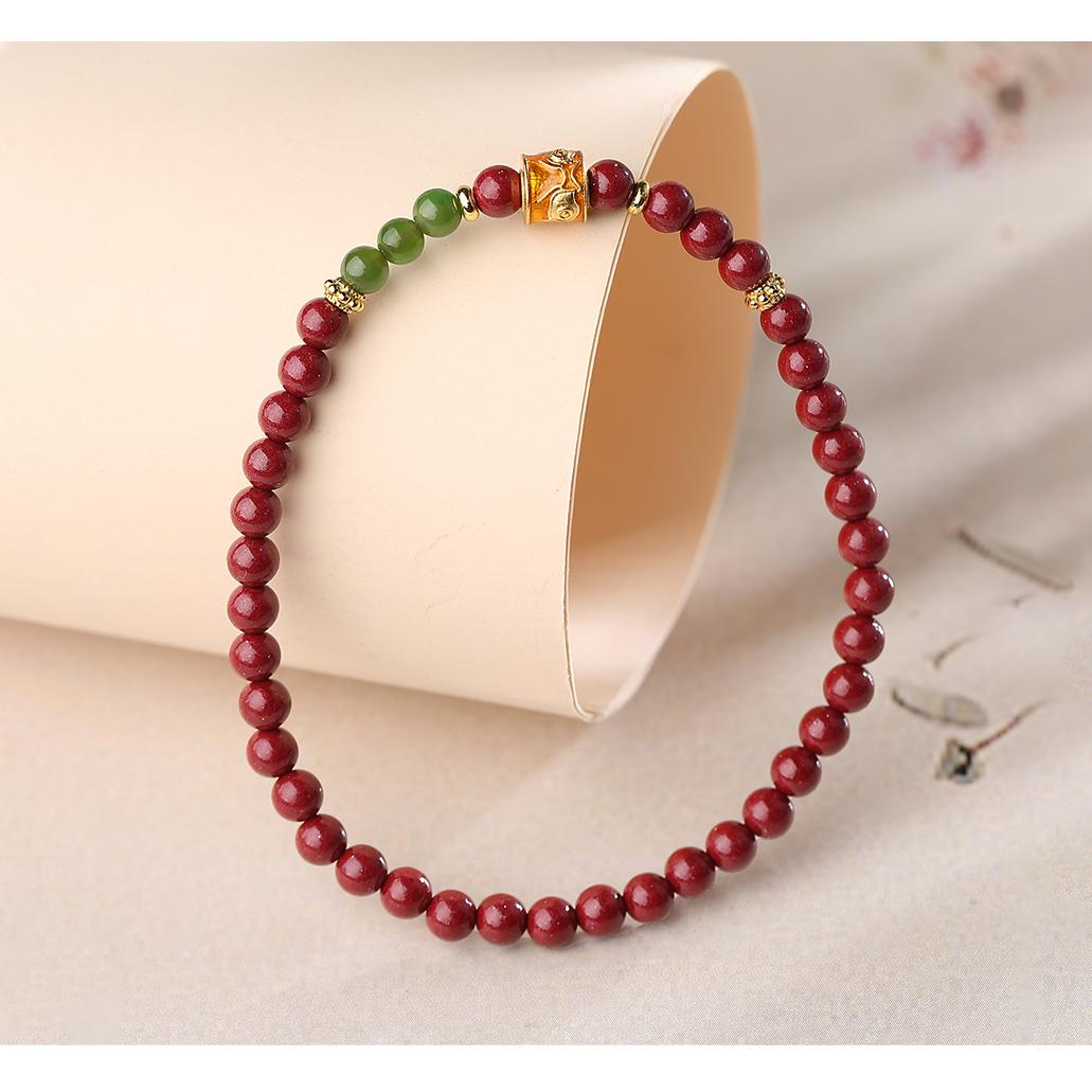Ode to Time Cinnabar and Jade bracelet in Tibetan Buddhist jewelry art, featuring hand-painted auspicious symbols for timeless blessings and protection.
