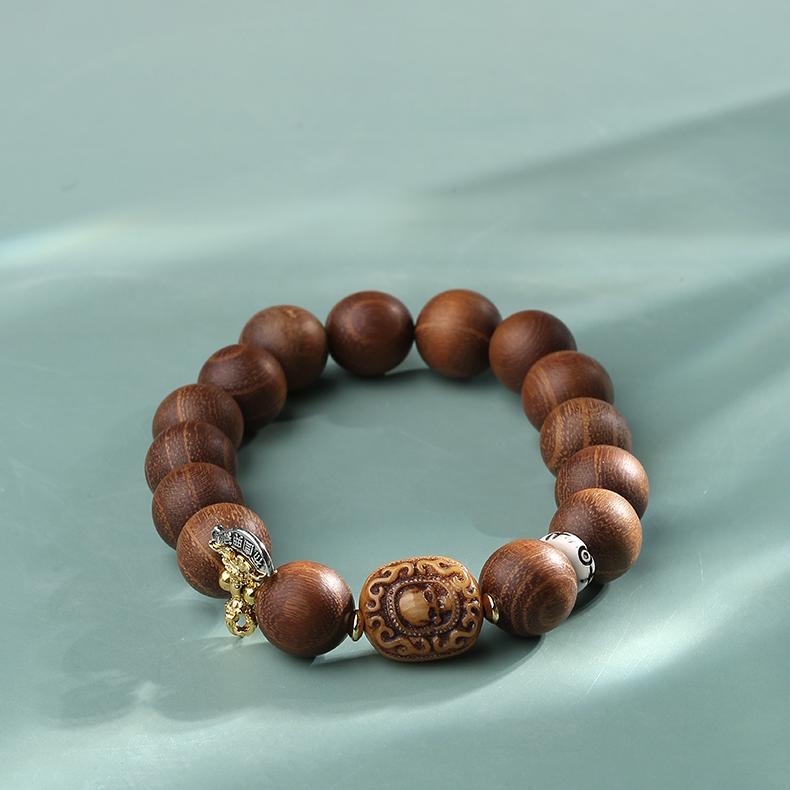 Close-up of the components of the Artisanal Bone-Inlaid Sandalwood Bracelet. Clearly shows the inlay craftsmanship between bone ornaments and golden sandalwood, highlighting the structure and stark contrast that emphasizes a rustic yet sacred Tibetan aesthetic.