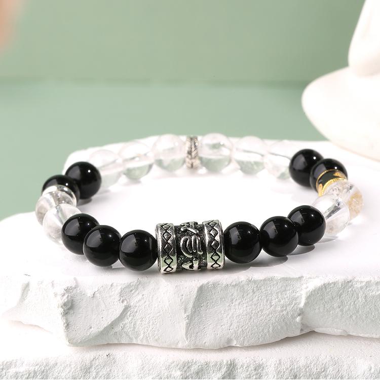 Main product image of Hand-Painted Obsidian and Crystal Bracelet. Features natural obsidian and clear quartz beads in alternating pattern, each bead adorned with artisan hand-painted Tibetan motifs, showcasing the energy balance beauty of Tibetan Buddhist jewelry art.
