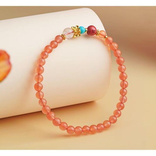 Main product image of Hand-Painted Red Queens Jasper Bracelet. Features natural red jasper and cinnabar beads in alternating pattern, each bead adorned with artisan hand-painted Tibetan auspicious motifs, showcasing the rich colors and sacred blessings of Tibetan Buddhist jewelry art.