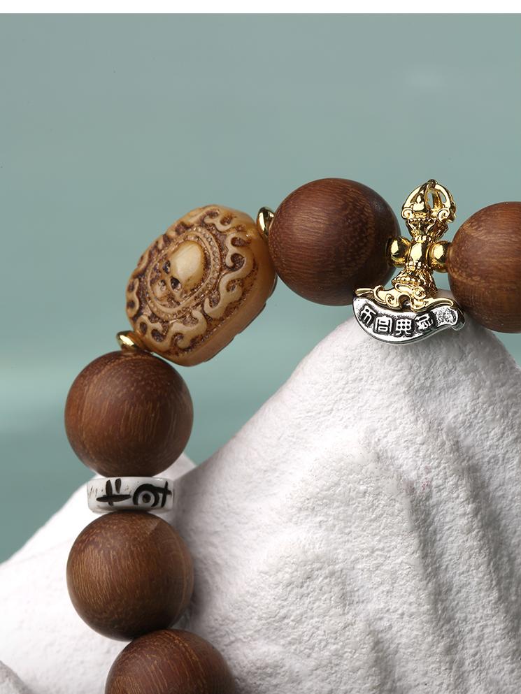  Styling shot of the Sacred 925 Silver and Golden Sandalwood Bracelet being worn. The sparkling silver accents and warm wooden beads complement each other on the wrist, emitting a serene and sacred aura that offers both protection and adornment.