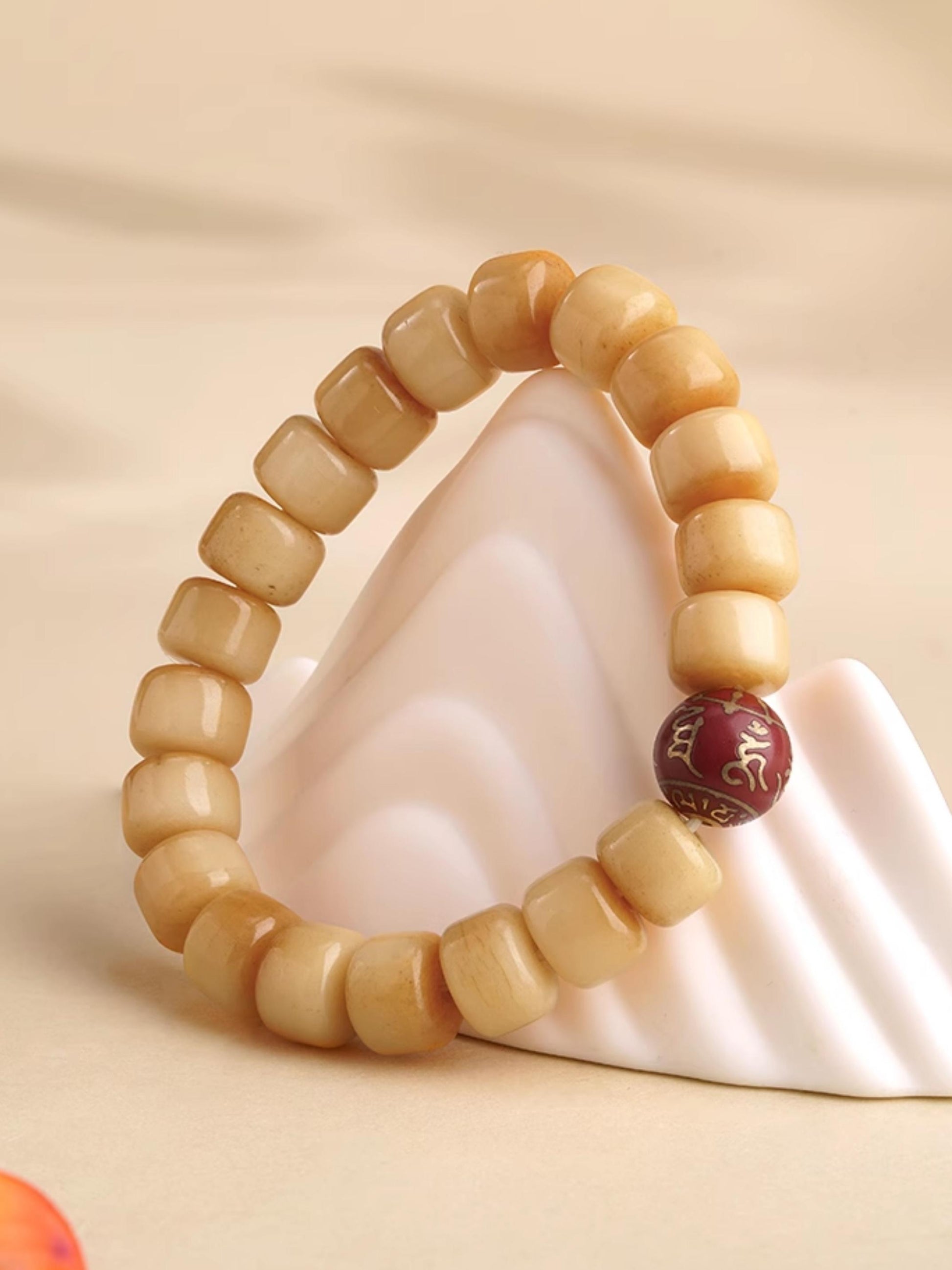 Ox bone ash protection bracelet in Tibetan Buddhist culture, featuring traditional hand-painted spiritual guardians.