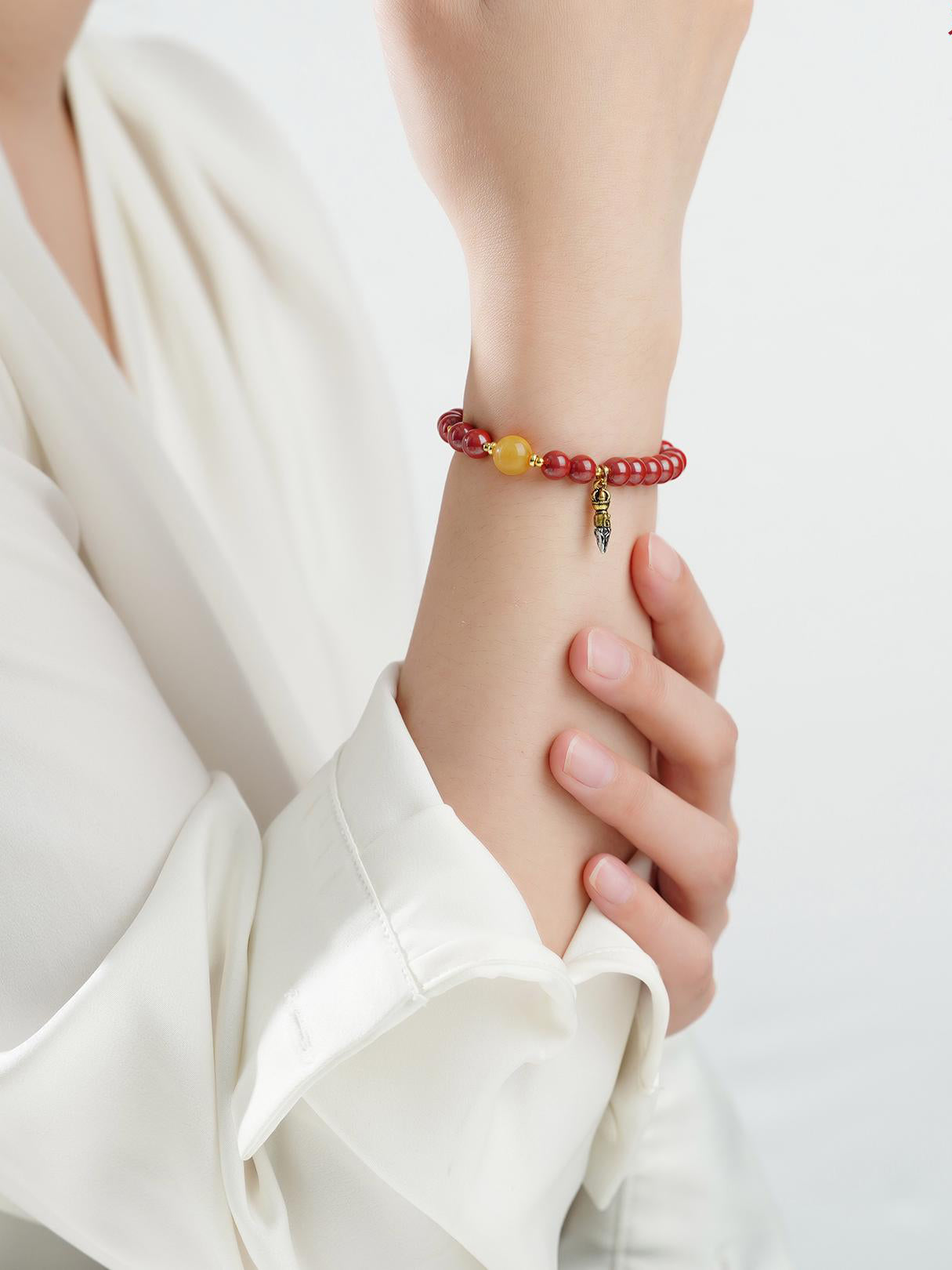 Sacred Cinnabar and Amber design in Tibetan Buddhist jewelry art, embodying prosperous energy and financial blessings.