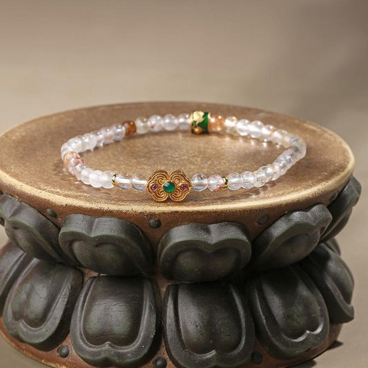 Hand-painted crystal and copper bracelet in Tibetan Buddhist jewelry art tradition, combining natural crystals with sacred metalwork for spiritual protection.