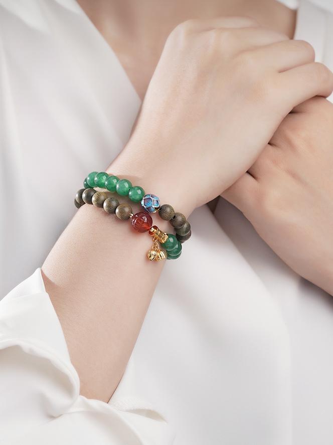 Artisanal green sandalwood and agate balance bracelet in Tibetan Buddhist jewelry tradition, featuring sacred geometric hand-painted patterns.