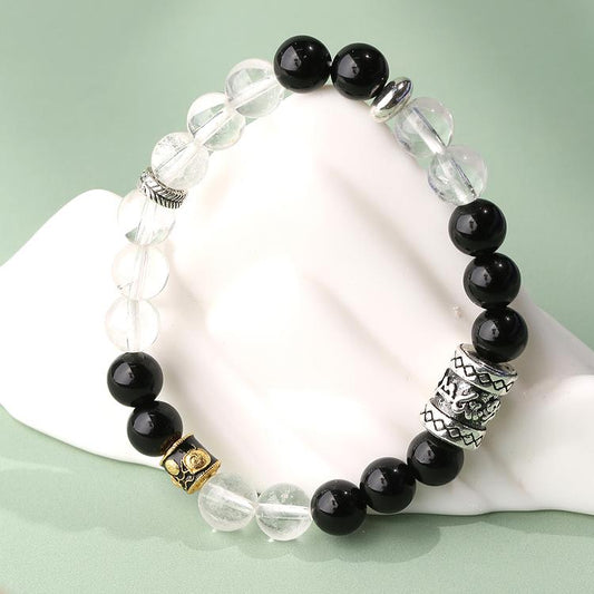 Close-up of Obsidian White Crystal Protection Bracelet. Dark obsidian symbolizes protection while clear quartz represents purification, this dual-gem combination creates a powerful energy shield, ideal for daily wear and spiritual protection.