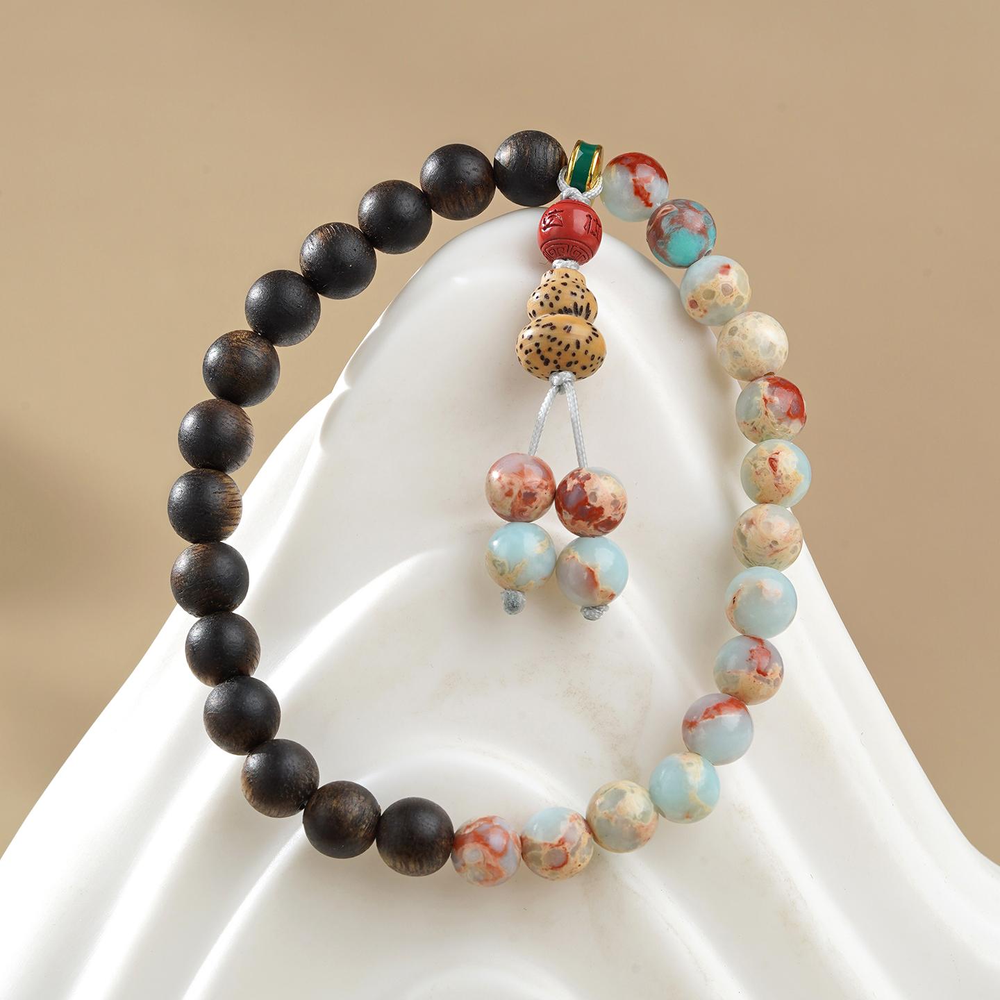 Hand-painted Shoushan Stone and Agarwood longevity bracelet in Tibetan Buddhist jewelry culture, combining sacred stones with precious wood for spiritual practice.