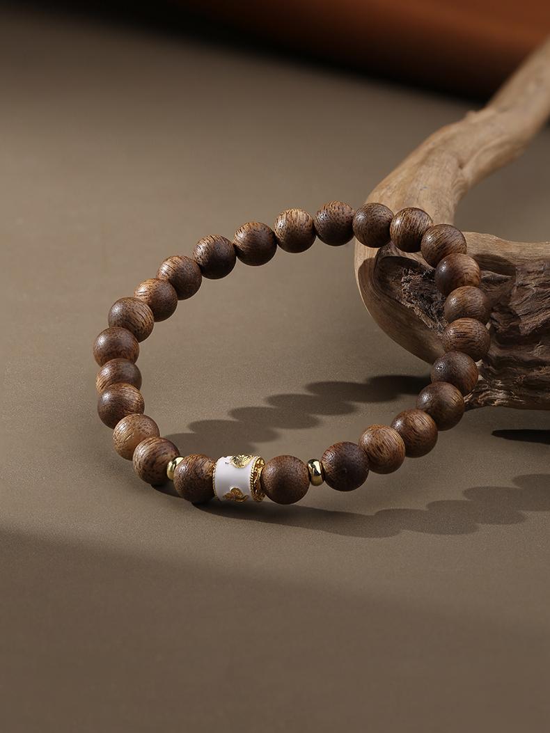 Snowy Mountain agarwood bracelet in Tibetan Buddhist jewelry art, featuring hand-painted mountain motifs symbolizing purity and spiritual elevation.