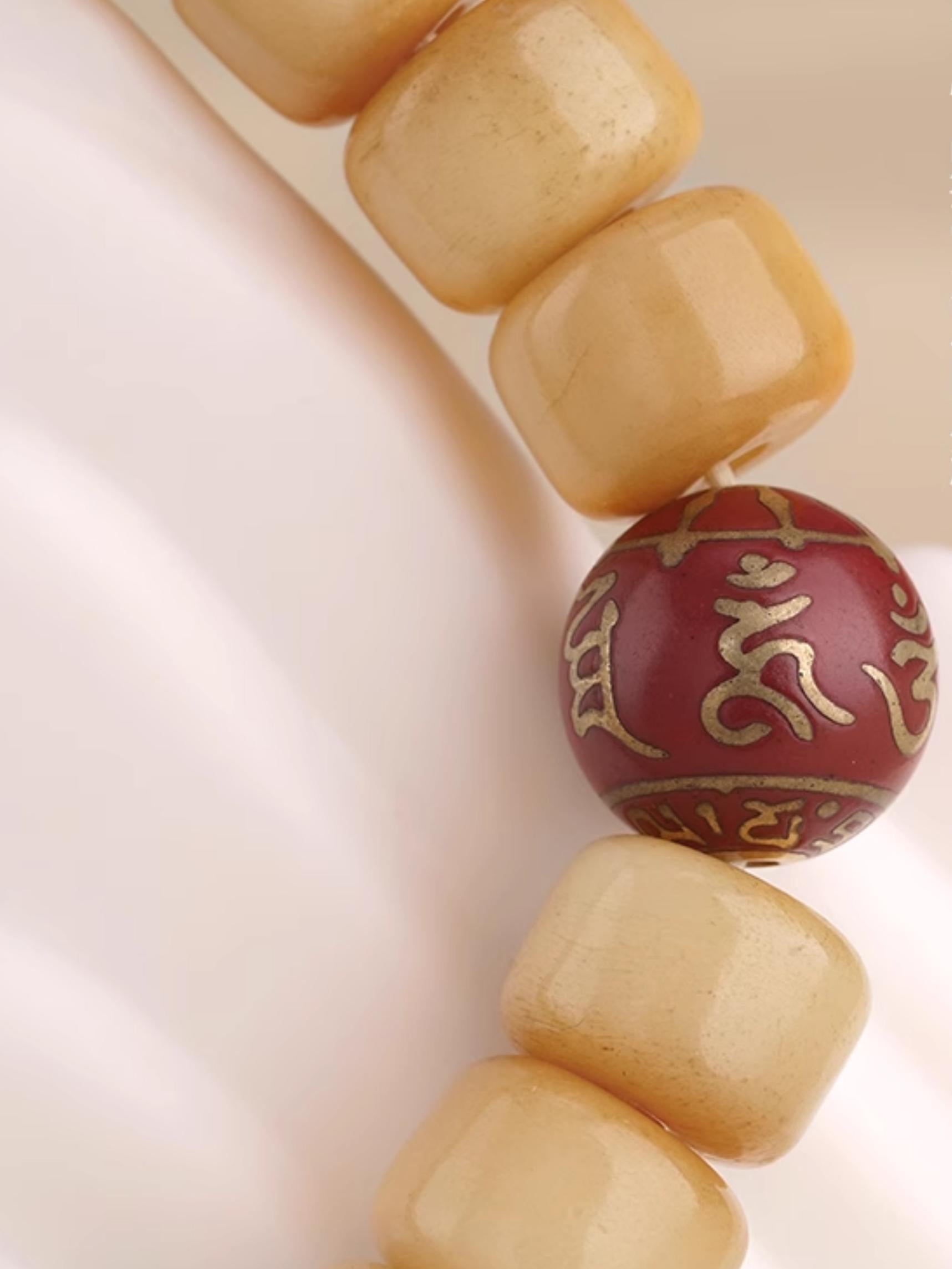 Hand-painted ritual beads for spiritual journey in Tibetan Buddhist jewelry art, crafted with sacred bone and incense materials.