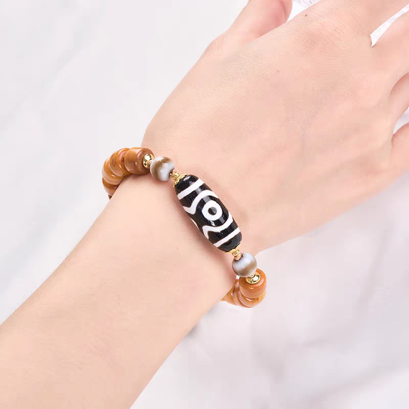 Authentic Panda-style three-eyed Dzi bead bracelet, showcasing Buddhist sacrificial items art and Tibetan Buddhist sacrificial implements culture. Purely handmade.