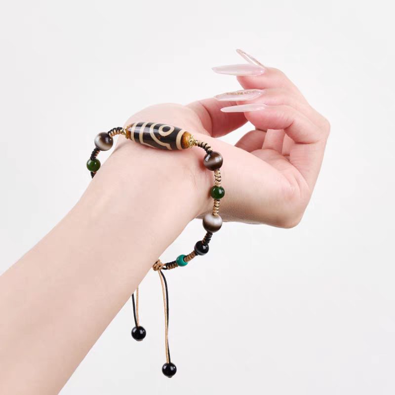 Authentic ivory yellow two-eyed Dzi bead bracelet, showcasing Buddhist sacrificial items art and Tibetan Buddhist sacrificial implements culture. Purely handmade.