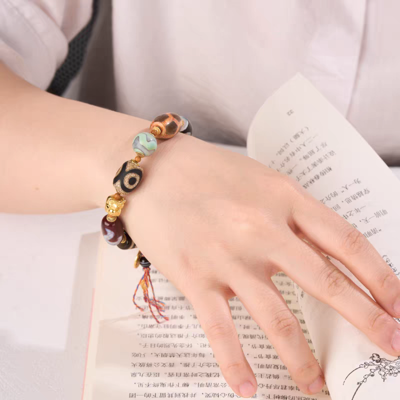 Authentic Darlok style Dzi bead bracelet, showcasing Buddhist sacrificial items art and Tibetan Buddhist sacrificial implements culture. Purely handmade.